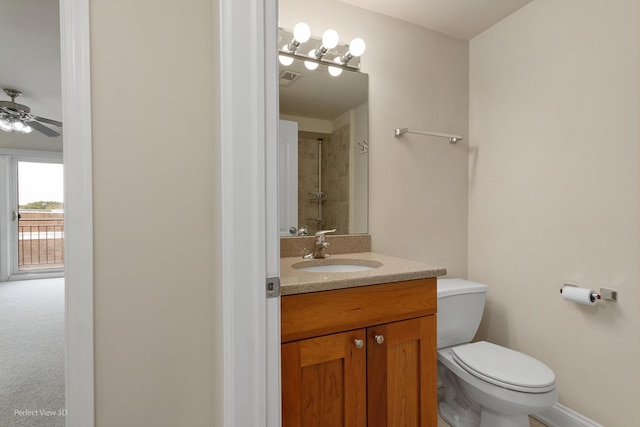 25 E 26th St Unit 4, Chicago, IL 60616 - bathroom with toilet, vanity, a ceiling fan, tiled shower, and baseboards