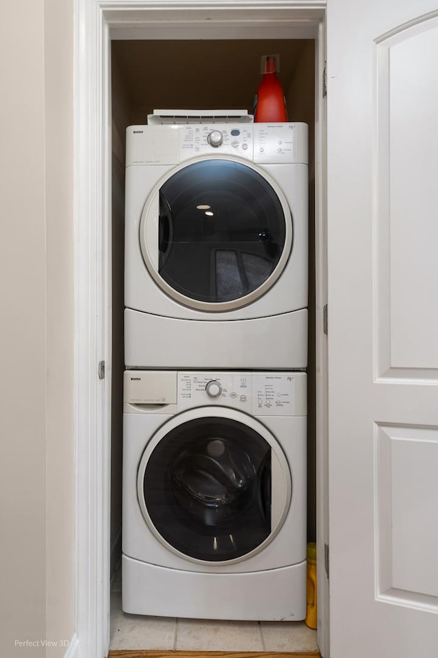 25 E 26th St Unit 4, Chicago, IL 60616 - laundry area featuring stacked washer / drying machine and tile patterned floors