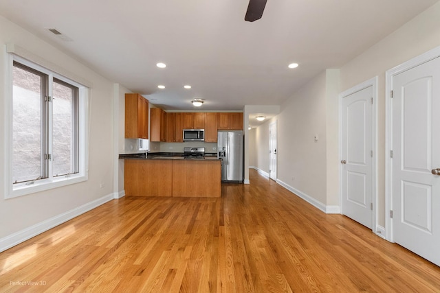 25 E 26th St Unit 4, Chicago, IL 60616 - kitchen with stainless steel appliances, a peninsula, light wood-style floors, baseboards, and recessed lighting