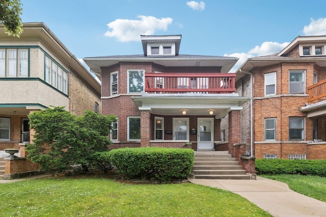 217 S Oak Park Ave, Oak Park, IL 60302 - view of front facade with a balcony, brick siding, a front lawn, and a porch