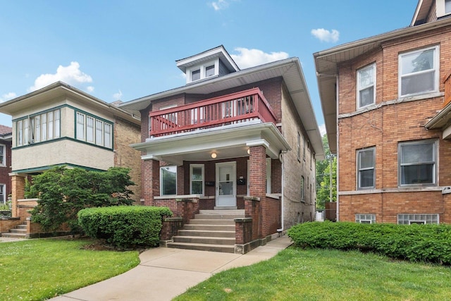 217 S Oak Park Ave, Oak Park, IL 60302 - traditional style home featuring a balcony, a front lawn, and brick siding