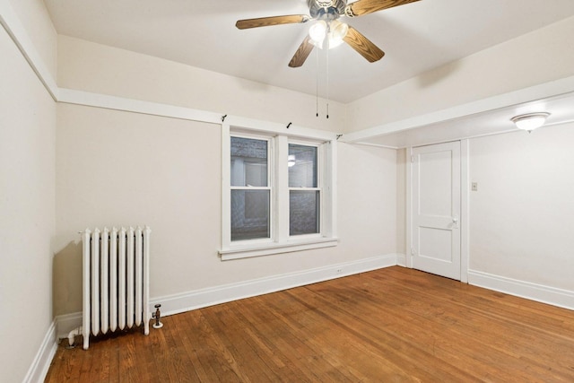 217 S Oak Park Ave, Oak Park, IL 60302 - spare room with radiator, wood finished floors, and a ceiling fan