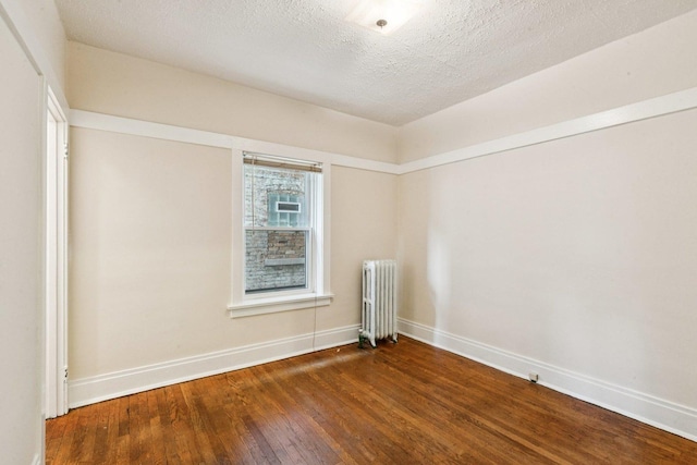 217 S Oak Park Ave, Oak Park, IL 60302 - empty room with radiator, hardwood / wood-style floors, and a textured ceiling
