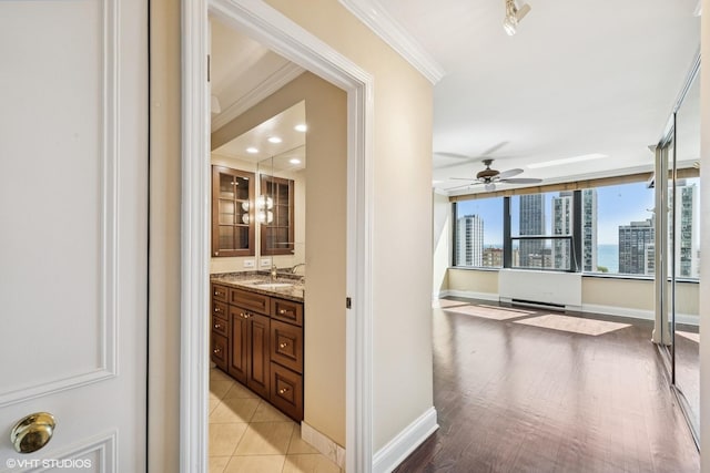 1560 N Sandburg Ter Unit 2202, Chicago, IL 60610 - hallway featuring a sink, ornamental molding, and baseboards