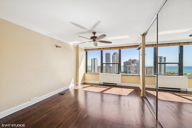 1560 N Sandburg Ter Unit 2202, Chicago, IL 60610 - unfurnished room featuring wood finished floors, crown molding, healthy amount of natural light, baseboards, and a ceiling fan