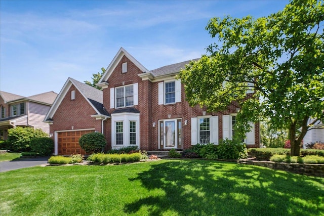 616 Meadowview Dr, West Chicago, IL 60185 - view of front facade featuring brick siding, a front lawn, asphalt driveway, and a garage