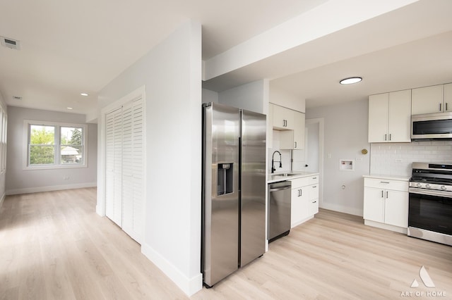 26415 W Beach St, Antioch, IL 60002 - kitchen with appliances with stainless steel finishes, light wood-style floors, a sink, light countertops, and baseboards