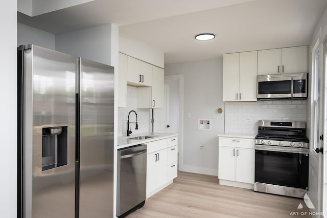 26415 W Beach St, Antioch, IL 60002 - kitchen featuring appliances with stainless steel finishes, a sink, tasteful backsplash, light countertops, and white cabinets