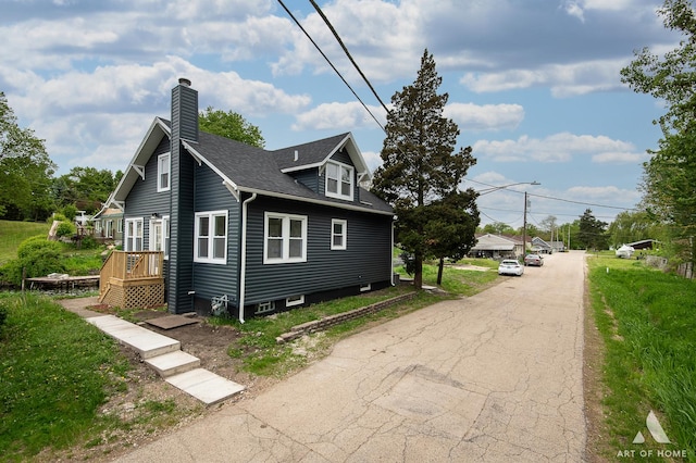 26415 W Beach St, Antioch, IL 60002 - view of home's exterior featuring a chimney and roof with shingles