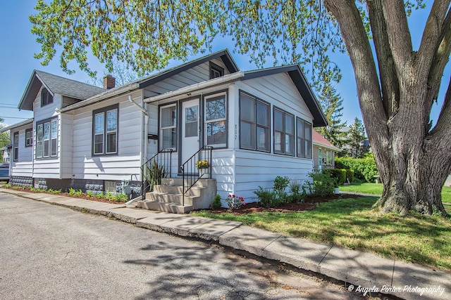 802 N Lewis Ave, Waukegan, IL 60085 - view of front of property with entry steps and a chimney