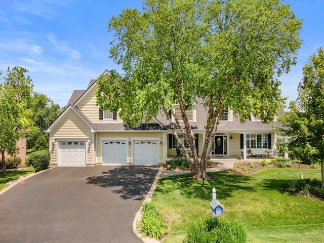 6312 Kingsbridge Dr, Cary, IL 60013 - view of front of property with driveway, a front yard, an attached garage, and roof with shingles
