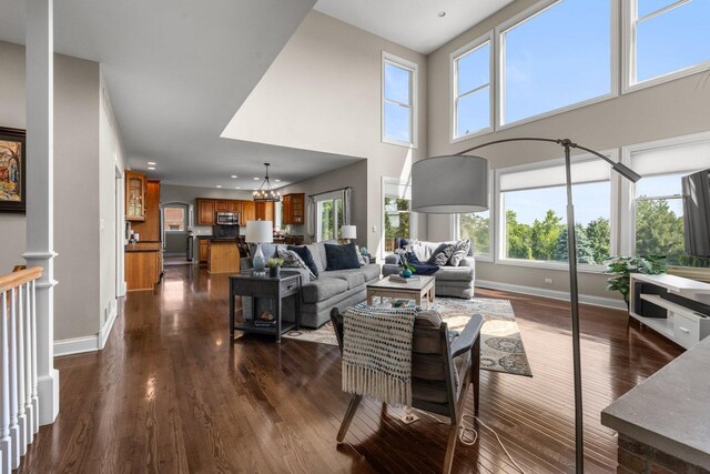 6312 Kingsbridge Dr, Cary, IL 60013 - living room featuring dark wood finished floors, a chandelier, a high ceiling, and recessed lighting