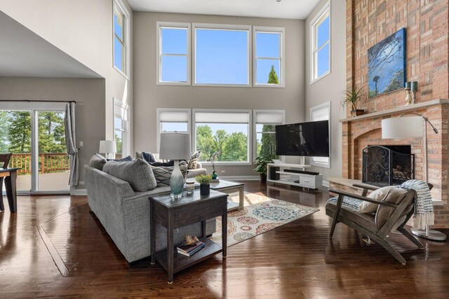 6312 Kingsbridge Dr, Cary, IL 60013 - living room with a high ceiling, hardwood / wood-style flooring, and a brick fireplace