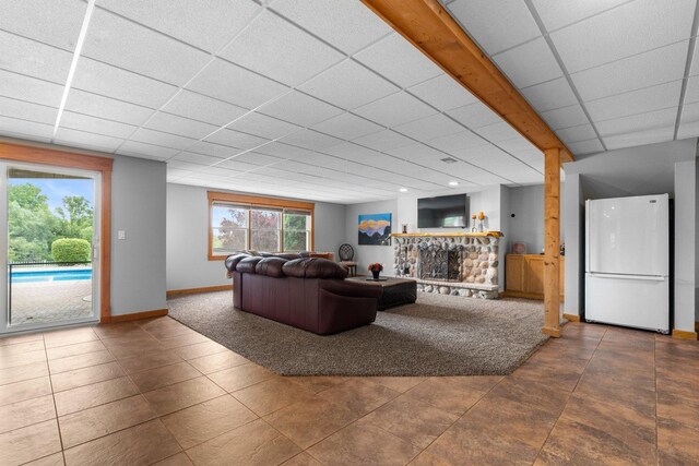 6312 Kingsbridge Dr, Cary, IL 60013 - tiled living room with a fireplace and a drop ceiling