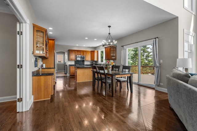 6312 Kingsbridge Dr, Cary, IL 60013 - dining room featuring arched walkways, dark wood-style floors, recessed lighting, and a chandelier
