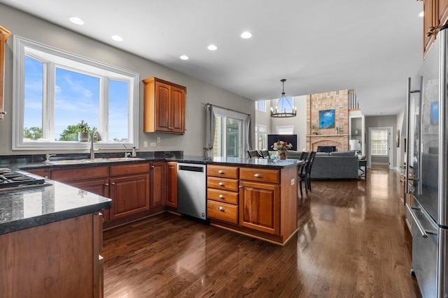 6312 Kingsbridge Dr, Cary, IL 60013 - kitchen featuring stainless steel appliances, brown cabinetry, dark wood-style floors, recessed lighting, and healthy amount of natural light