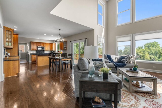 6312 Kingsbridge Dr, Cary, IL 60013 - living area with dark wood-style flooring, plenty of natural light, arched walkways, recessed lighting, and a chandelier