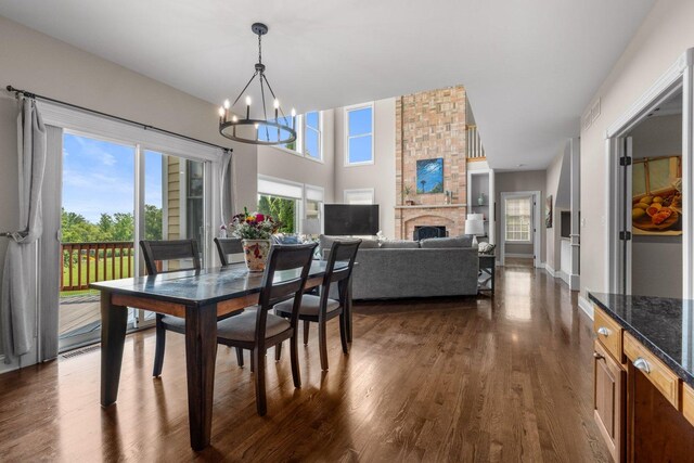 6312 Kingsbridge Dr, Cary, IL 60013 - dining room featuring a chandelier, dark wood finished floors, and a fireplace
