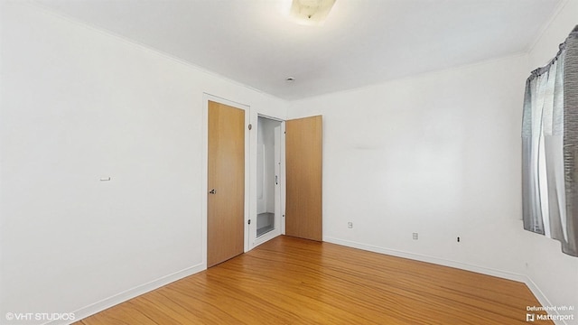 6145 S Nashville Ave, Chicago, IL 60638 - spare room with light wood-style flooring, baseboards, and ornamental molding