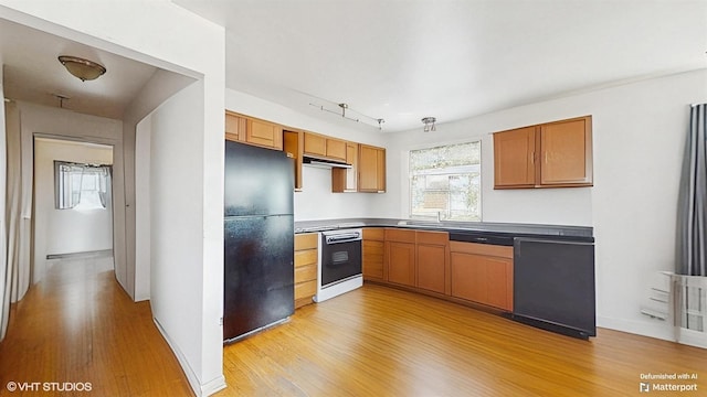 6145 S Nashville Ave, Chicago, IL 60638 - kitchen featuring black appliances, light wood finished floors, under cabinet range hood, and dark countertops