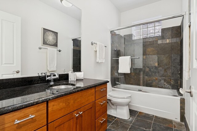 3823 N Wayne Ave, Chicago, IL 60613 - bathroom with vanity, toilet, shower / bath combination with glass door, and stone finish flooring