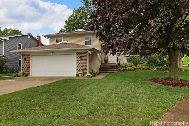 4125 Victoria Dr, Hoffman Estates, IL 60192 - view of front facade featuring an attached garage, a front lawn, concrete driveway, and brick siding
