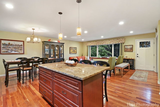 4125 Victoria Dr, Hoffman Estates, IL 60192 - kitchen featuring a breakfast bar, light wood-style floors, recessed lighting, hanging light fixtures, and a kitchen island