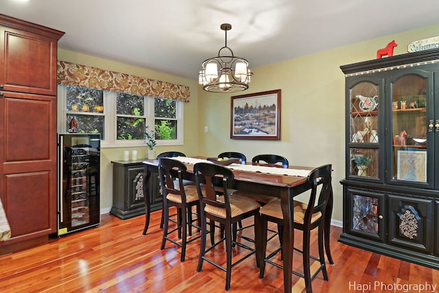 4125 Victoria Dr, Hoffman Estates, IL 60192 - dining room featuring wine cooler, light wood-style floors, a chandelier, and bar area
