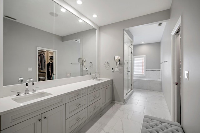 1429 S Prairie Ave, Chicago, IL 60605 - full bathroom with double vanity, a garden tub, a stall shower, marble look tiles, and recessed lighting