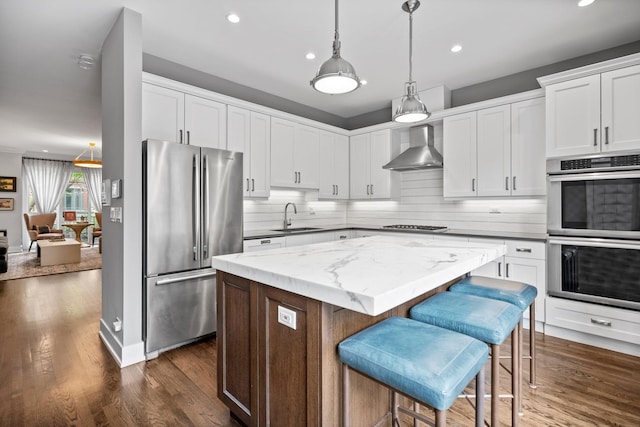 1429 S Prairie Ave, Chicago, IL 60605 - kitchen with appliances with stainless steel finishes, wall chimney range hood, a sink, recessed lighting, and a center island