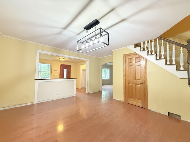 1634 Scott Blvd, Geneva, IL 60134 - unfurnished living room featuring wood finished floors, plenty of natural light, arched walkways, stairway, and ornamental molding