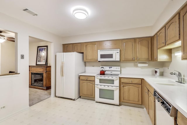 7525 Nantucket Dr Unit 106, Darien, IL 60561 - kitchen with white appliances, a sink, light floors, light countertops, and a glass covered fireplace
