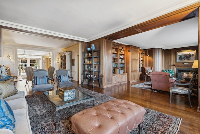 199 E Lake Shore Dr Unit 3, Chicago, IL 60611 - living room with crown molding, wood finished floors, a lit fireplace, built in shelves, and a chandelier