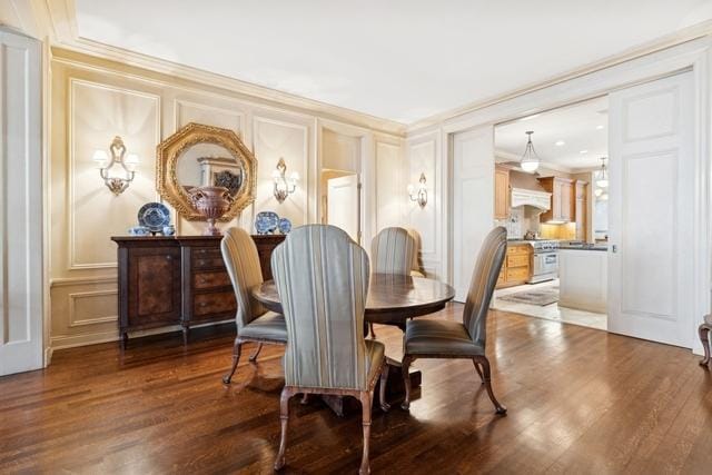 199 E Lake Shore Dr Unit 3, Chicago, IL 60611 - dining area with a decorative wall, crown molding, and wood finished floors