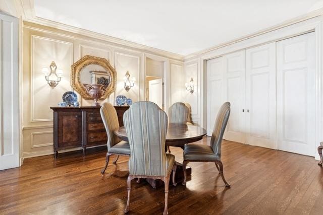 199 E Lake Shore Dr Unit 3, Chicago, IL 60611 - dining area featuring a decorative wall, wood finished floors, and crown molding