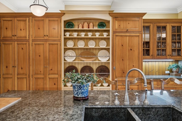 199 E Lake Shore Dr Unit 3, Chicago, IL 60611 - kitchen view of a sink, ornamental molding, brown cabinets, dark stone countertops, and glass insert cabinets