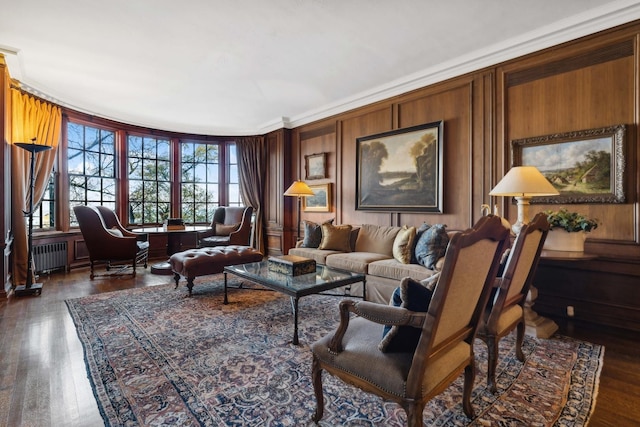 199 E Lake Shore Dr Unit 3, Chicago, IL 60611 - living room with radiator heating unit, ornamental molding, dark wood-style flooring, and wooden walls