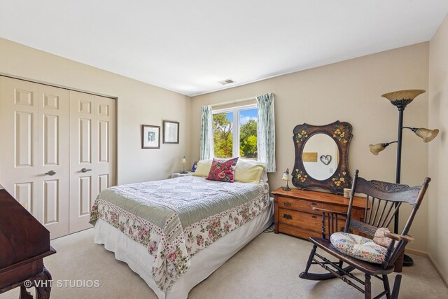 bedroom featuring a closet and light carpet