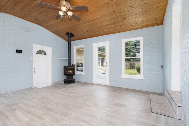 11S561 Saratoga Ave, Lemont, IL 60439 - unfurnished living room with wooden ceiling, vaulted ceiling, brick wall, a wood stove, and ceiling fan