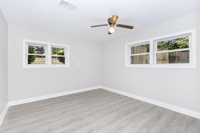 11S561 Saratoga Ave, Lemont, IL 60439 - empty room with healthy amount of natural light, wood finished floors, ceiling fan, and baseboards