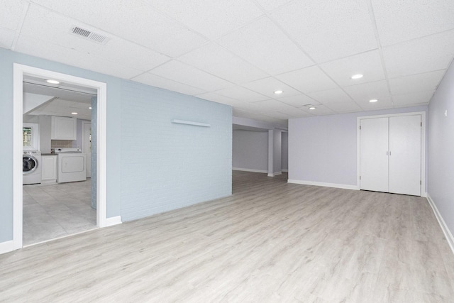11S561 Saratoga Ave, Lemont, IL 60439 - unfurnished living room with washer / dryer, light wood-type flooring, baseboards, a drop ceiling, and recessed lighting