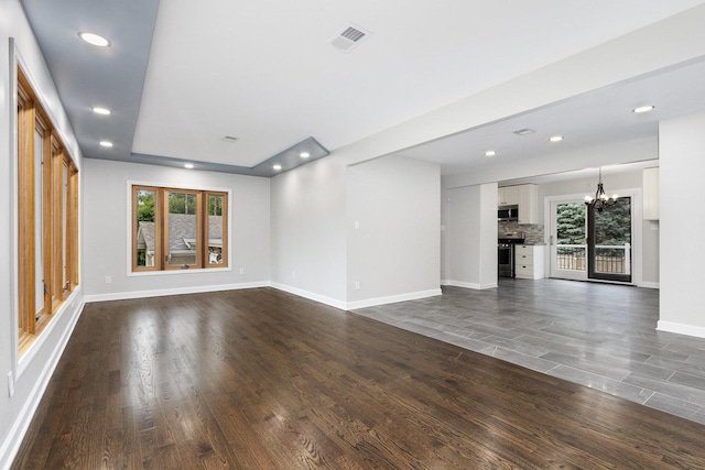 11S561 Saratoga Ave, Lemont, IL 60439 - unfurnished living room with a chandelier, dark wood-type flooring, baseboards, and recessed lighting