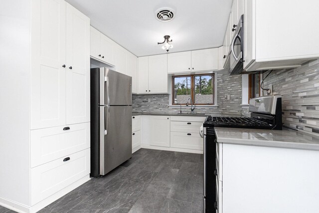 11S561 Saratoga Ave, Lemont, IL 60439 - kitchen with appliances with stainless steel finishes, a sink, backsplash, and white cabinetry