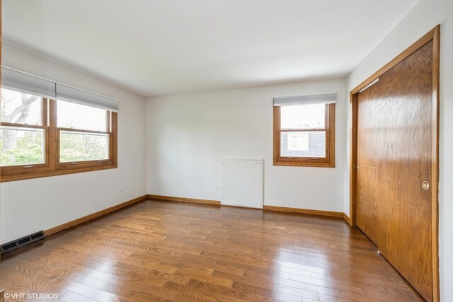 6483 Indianhead Trl, Indian Head Park, IL 60525 - unfurnished bedroom with a closet, wood finished floors, and baseboards