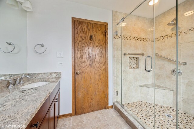 6483 Indianhead Trl, Indian Head Park, IL 60525 - bathroom with a shower stall, vanity, tile patterned flooring, and baseboards
