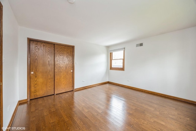 6483 Indianhead Trl, Indian Head Park, IL 60525 - unfurnished bedroom featuring wood finished floors, baseboards, and a closet