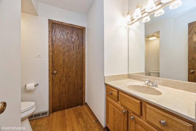 6483 Indianhead Trl, Indian Head Park, IL 60525 - bathroom with toilet, wood finished floors, and vanity