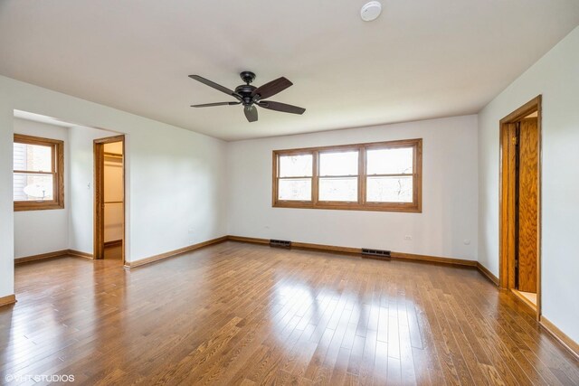 6483 Indianhead Trl, Indian Head Park, IL 60525 - empty room with healthy amount of natural light, a smoke detector, baseboards, and wood finished floors