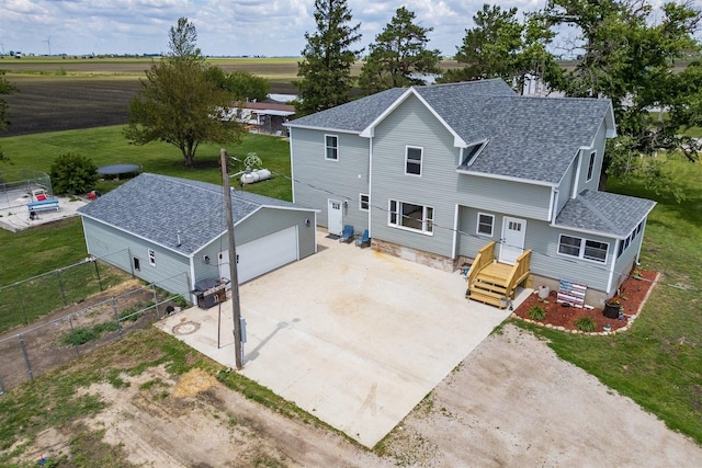 17469 N 300 E Rd, Flanagan, IL 61740 - rear view of property featuring roof with shingles, an outbuilding, a detached garage, and driveway