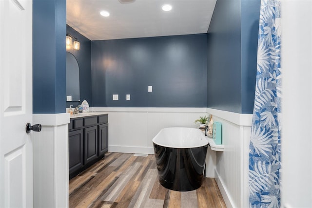 17469 N 300 E Rd, Flanagan, IL 61740 - full bathroom featuring vanity, a wainscoted wall, wood finished floors, a soaking tub, and recessed lighting